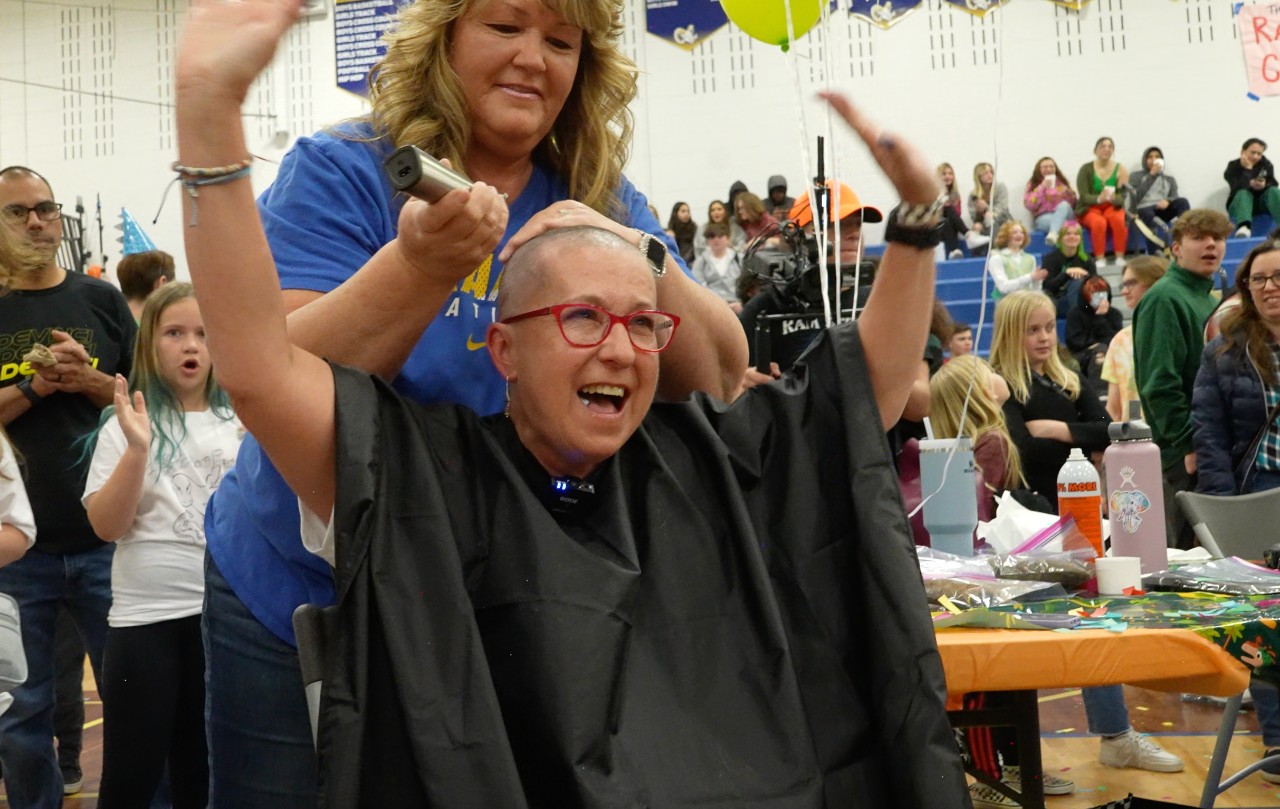 Tana Tornquist celebrates her new bald head as she participates in Rampart High School's Bald 4 Bucks fundraiser